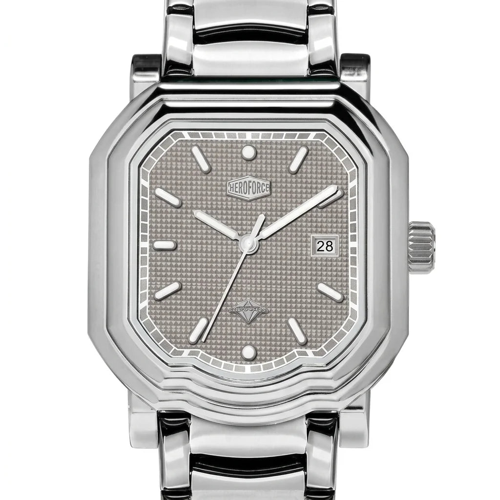 Upclose view - Silver wristwatch with octagonal rectangular case, metallic bracelet, gray textured dial, silver markers, and date window