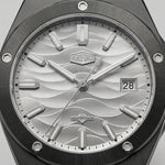 Upclose view of A men's analog watch with a black metal case and link bracelet, featuring a silver dial with a wavy pattern, silver hour markers