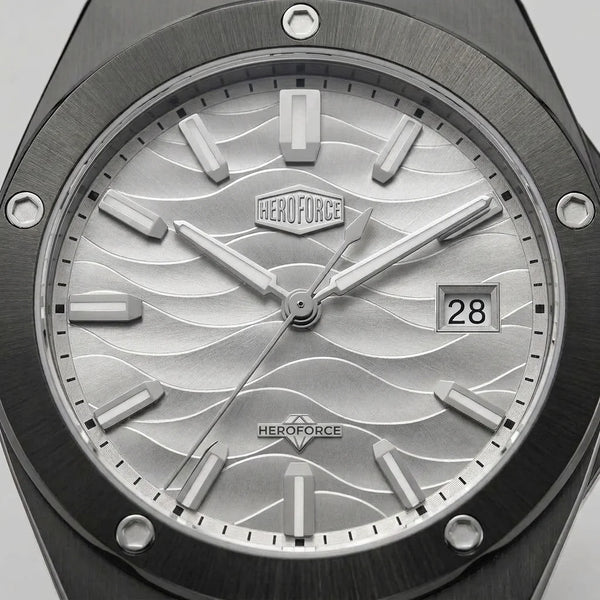 Upclose view of A men's analog watch with a black metal case and link bracelet, featuring a silver dial with a wavy pattern, silver hour markers