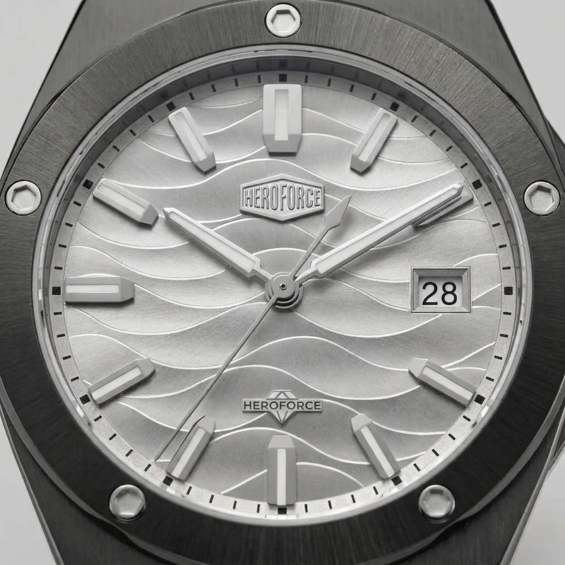 Upclose view of A men's analog watch with a black metal case and link bracelet, featuring a silver dial with a wavy pattern, silver hour markers