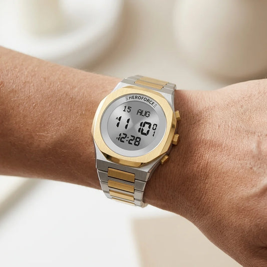 Wrist worn of Round digital wristwatch with alternating silver and gold segmented band, gold bezel, and three gold side buttons