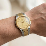 Wrist worn of Silver and Gold Stainless Steel Watch with Gold Textured Dial