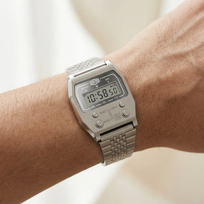 Wrist worn of Silver digital wristwatch with rectangular face and segmented band, display showing brand “HEROFORCE,”