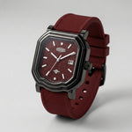 A rugged octagonal analog watch with a dark gunmetal gray case, a textured burgundy dial