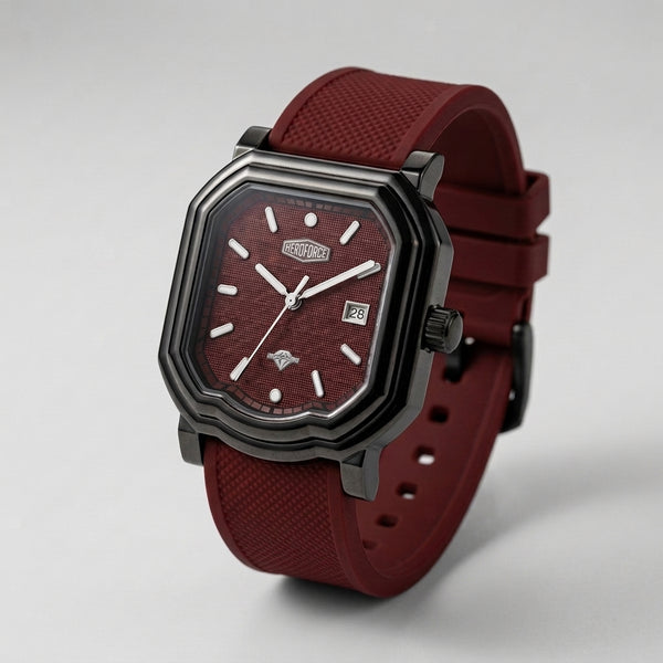 A rugged octagonal analog watch with a dark gunmetal gray case, a textured burgundy dial