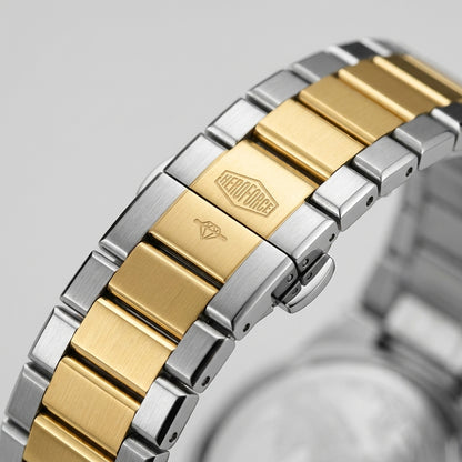 Close-up of a two-tone stainless steel and gold link watch band with a brushed metal finish, featuring a visible HEROFORCE brand logo engraved on a gold link.