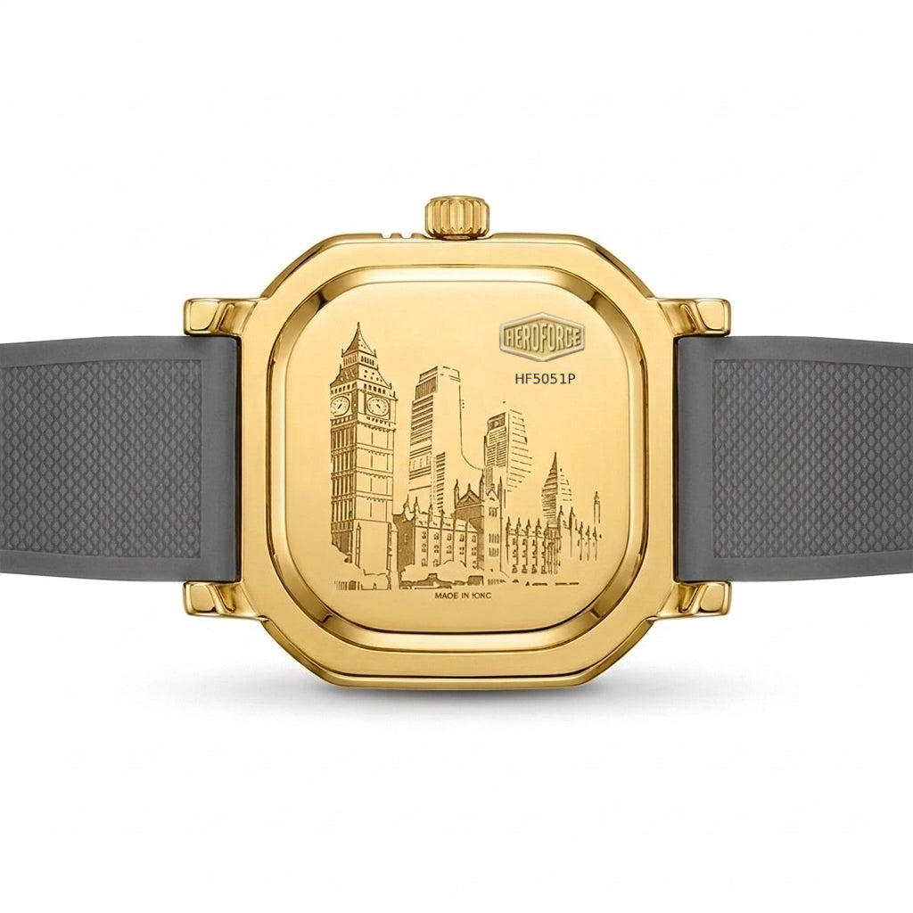 A gold-toned wristwatch shown from the back, featuring an engraved London cityscape on the case and a dark gray textured strap, photographed on a clean white background.