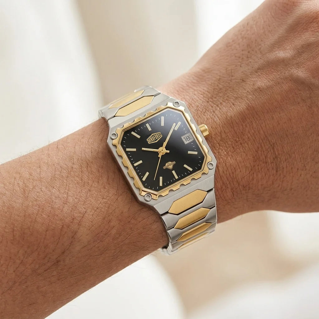 A two-tone stainless steel and gold watch with a black dial, shown worn on a person's wrist.