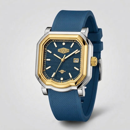 A men's analog watch with an octagonal bezel, featuring a blue textured dial, gold-tone hands and markers, a silver-tone case, and a blue silicone strap, shown on a light gray background.